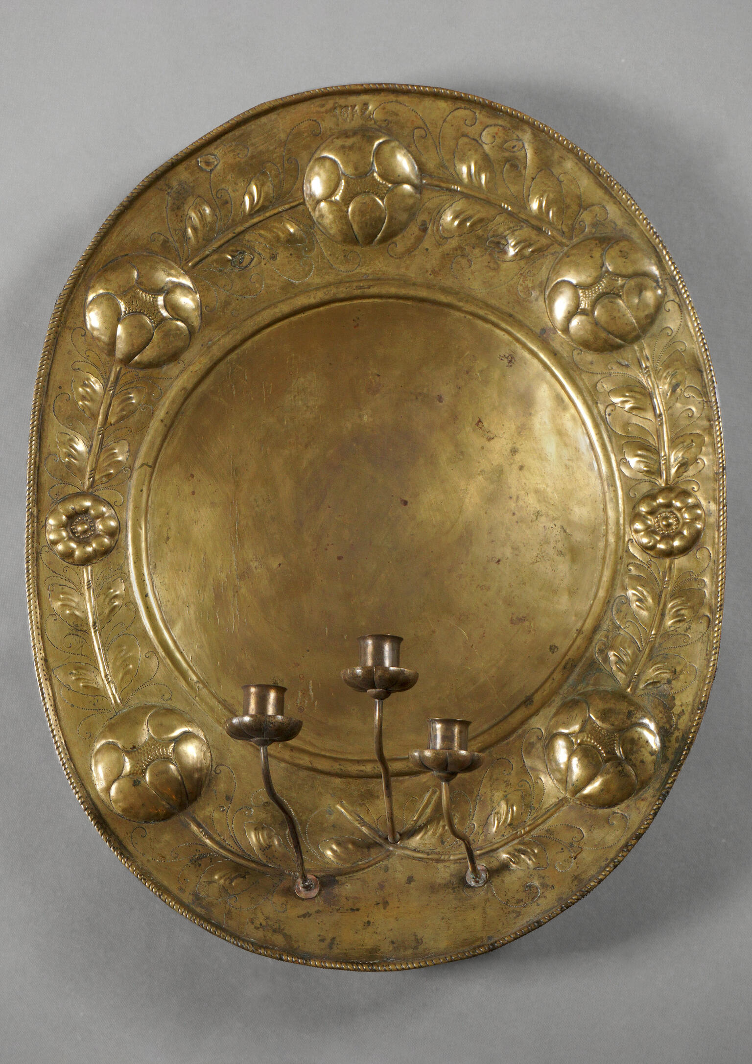 Metal oval with three candlestick holders. 