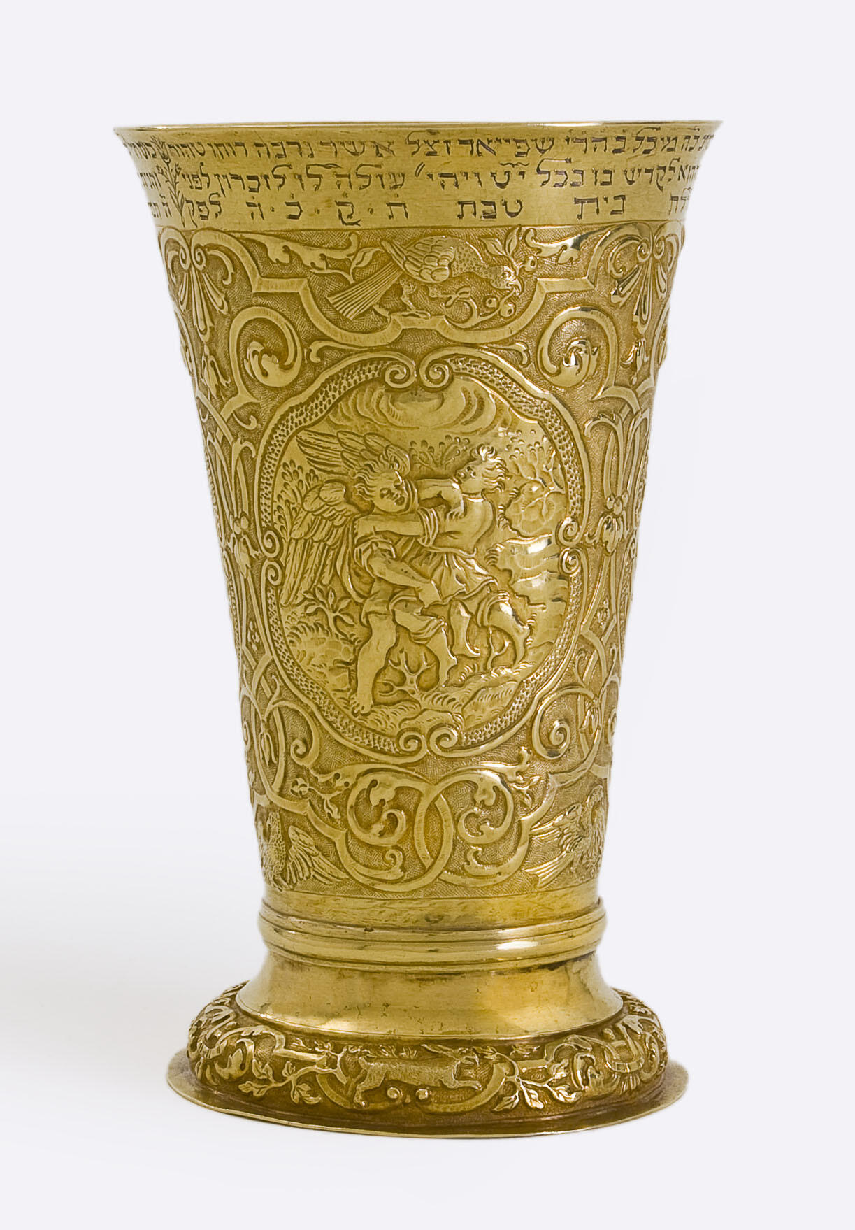 Goblet inscribed with angels, birds, and other animals with a floral motif, and Hebrew text across the lip. 