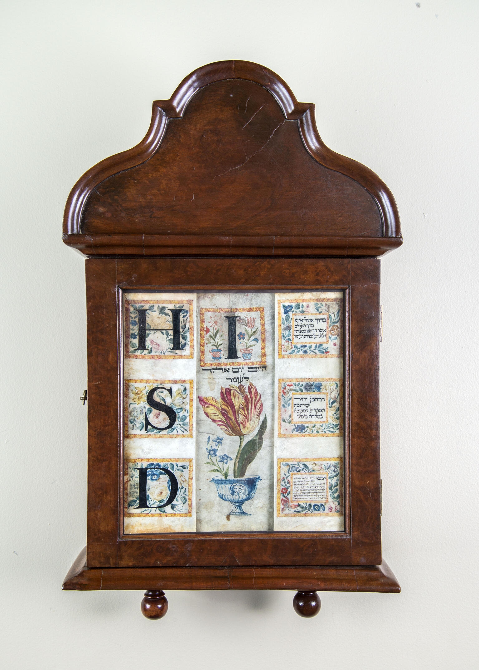 Wood wall piece with bold Hebrew letters and flowers