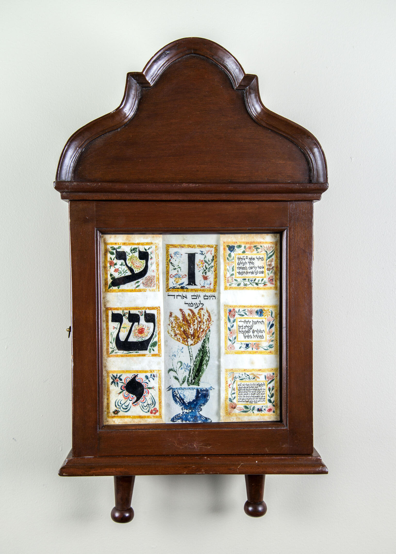 Wood wall piece with bold English letters and flowers. 