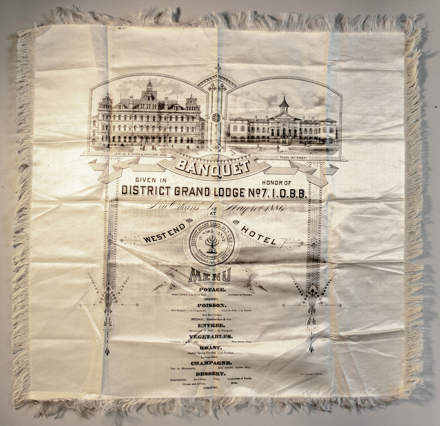 Cloth with image of buildings and menu in English printed on it.