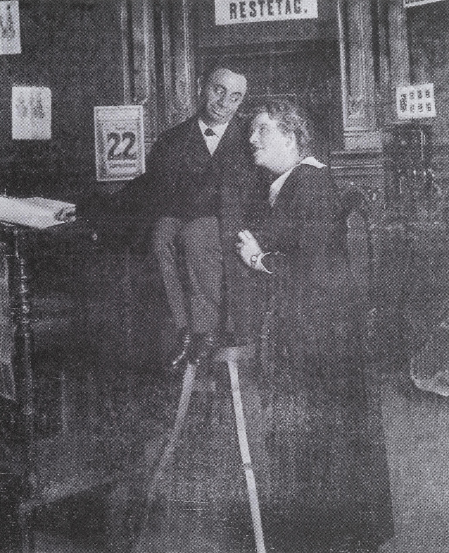 Photograph of two figures looking at each other.