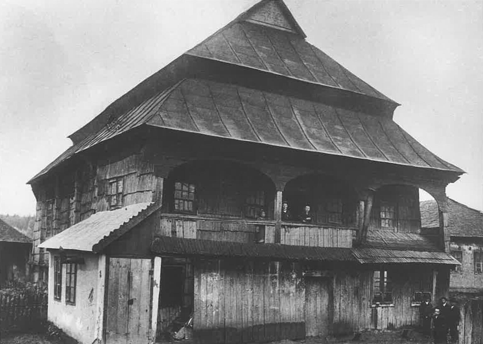 Photograph of wooden building with tiered triangular roof. Photograph of wooden building with tiered triangular roof.