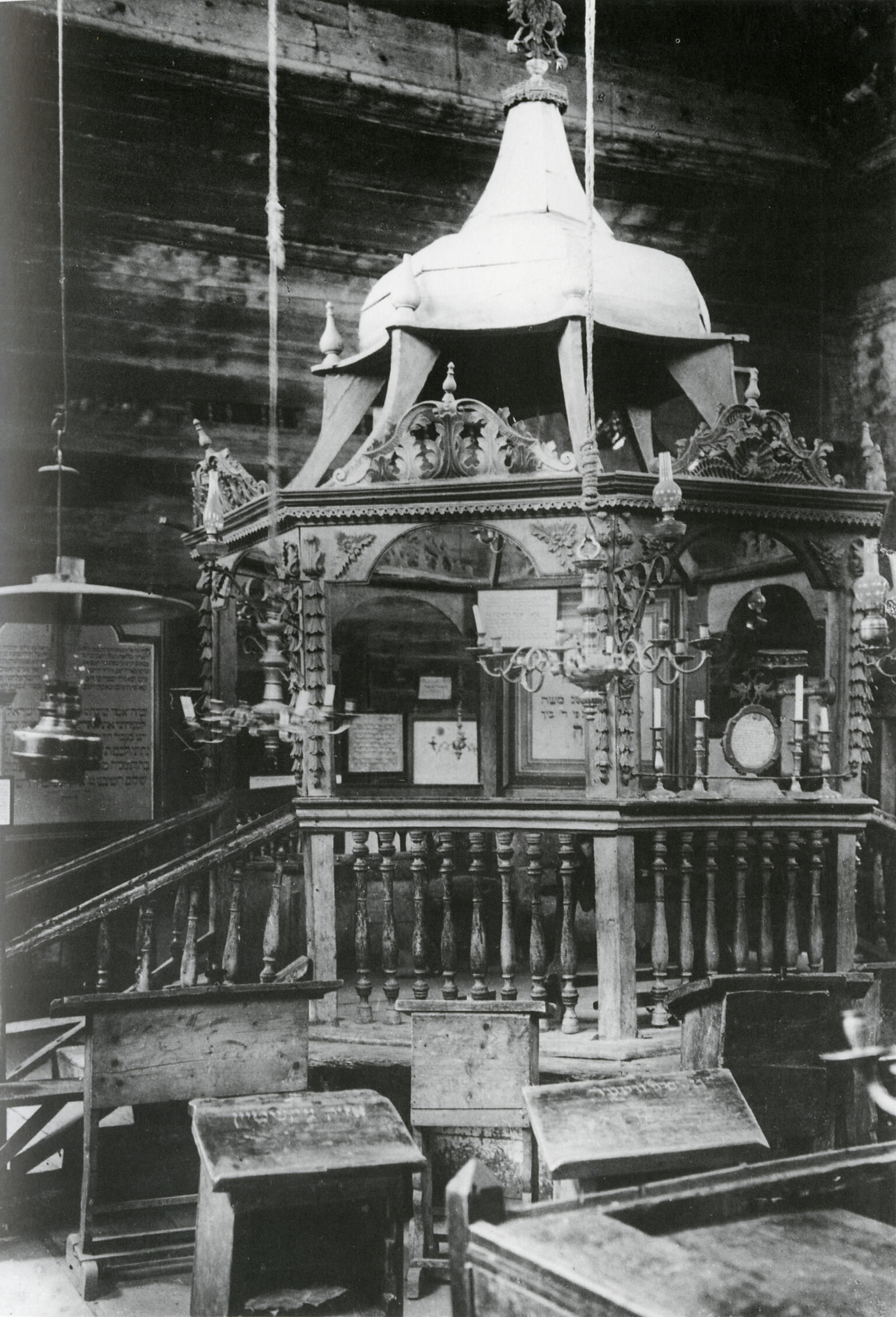 Photograph of platform with short staircase, conical roof, and elaborate pendant lamps. Photograph of platform with short staircase, conical roof, and elaborate pendant lamps.