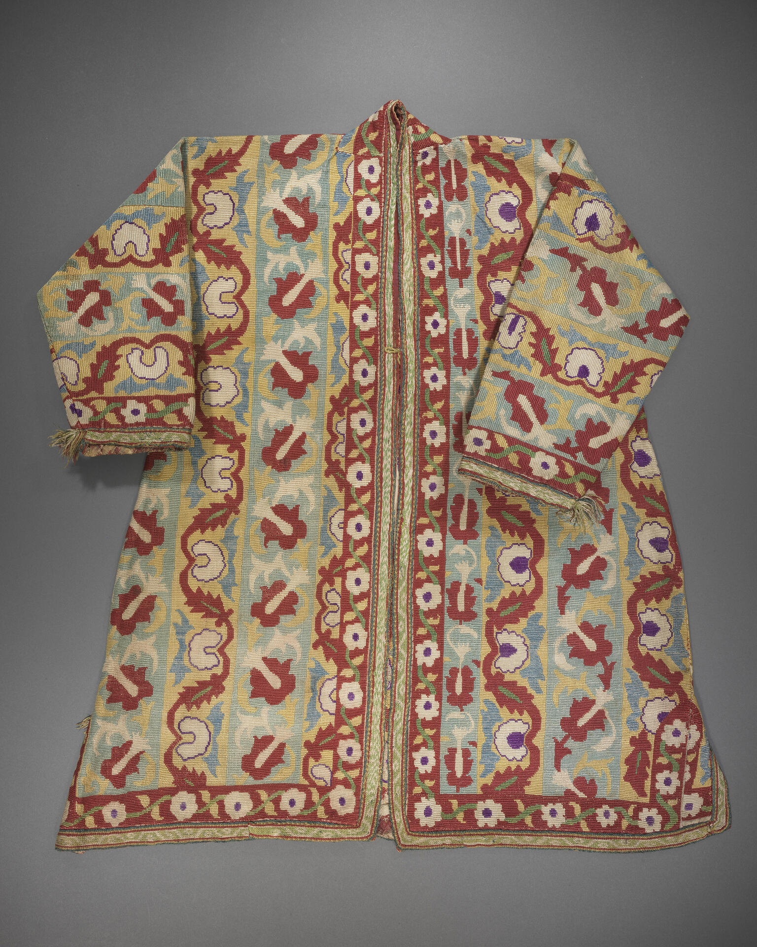 Coat embroidered with flowers, vines, and geometric patterns.