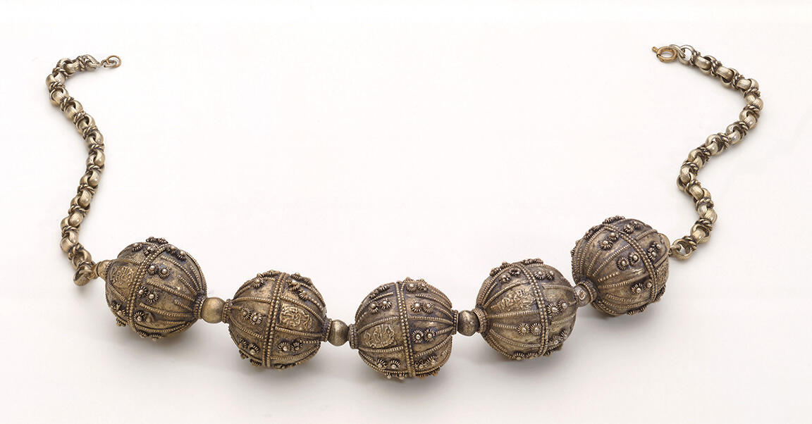 Necklace with five large beads on chain.
