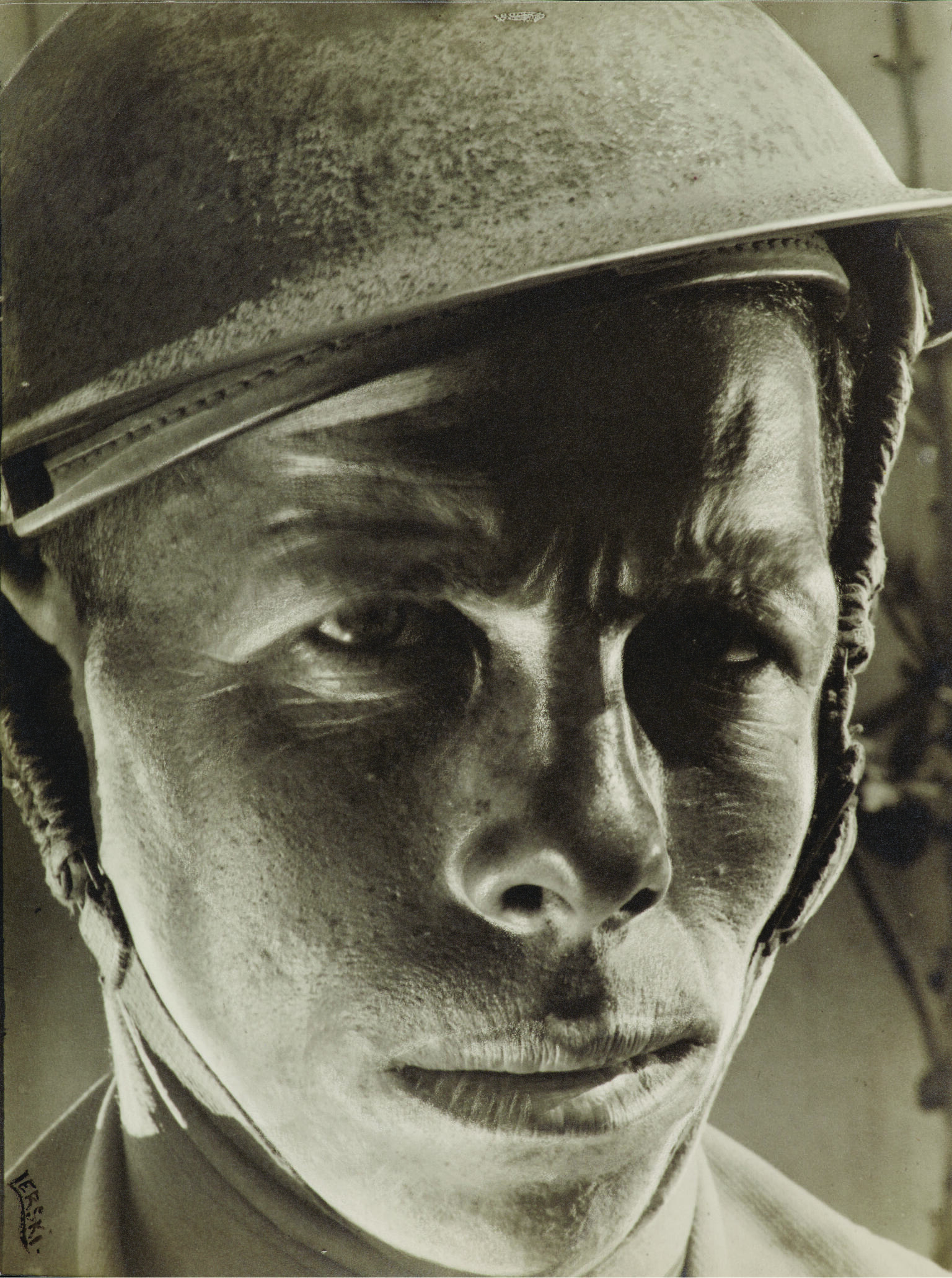 Portrait photograph of soldier wearing helmet and stern expression. Portrait photograph of soldier wearing helmet and stern expression.