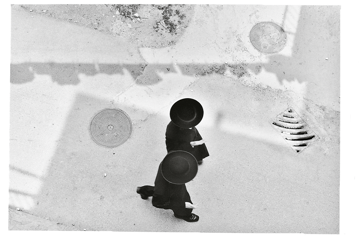 Aerial photograph of two people in hats and suits walking. Aerial photograph of two people in hats and suits walking.