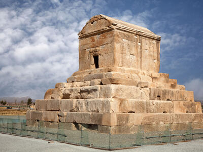 Photograph of stone tomb on top of tiered platform. 