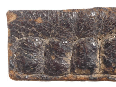 Leather capsule with four indented sections.