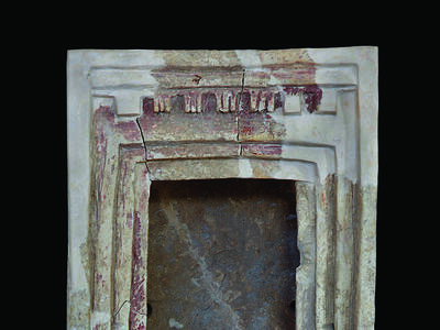 Terra-cotta shrine with capitals at entrance.