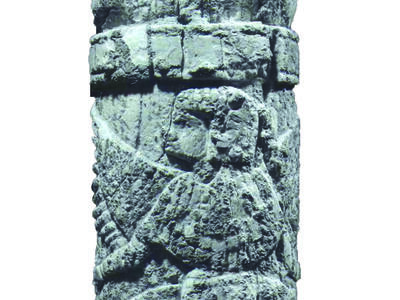 Front of a bone handle with winged humanoid grasping branches of palm tree.