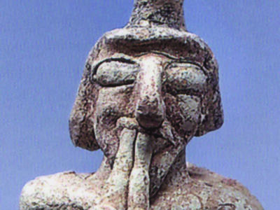 Ceramic figure playing a double pipe.