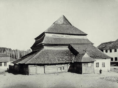 Photograph of wooden building exterior with several layers of roofs.