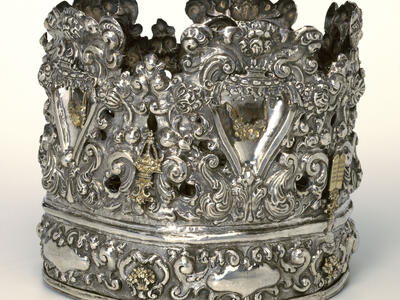 Crown with decorative carvings.