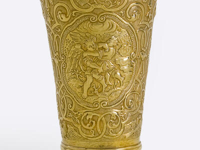 Goblet inscribed with angels, birds, and other animals with a floral motif, and Hebrew text across the lip. 