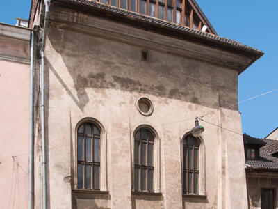 Exterior photograph of building with arched windows and triangular room.  