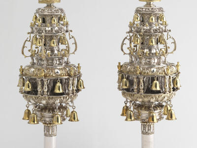 Finials with many layers of branches with bells and topped with crowns.