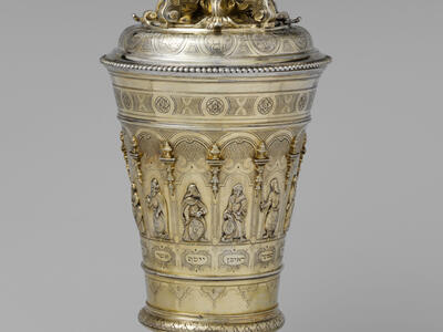 Silver cup with engraving of biblical figures along base and astrological figures and decorative designs on lid. 