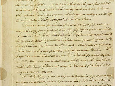 Handwritten letter in English with small stamp at top and signature on bottom.