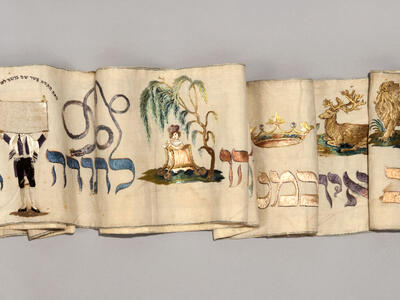 Textile featuring paintings of various animals and a crown.