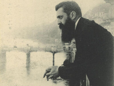 Herzl Observing the Rhine from the Balcony of Hotel Les Trois Rois during the Fifth Zionist Congress in 1901 in Basel Photograph of man leaning over a bridge.