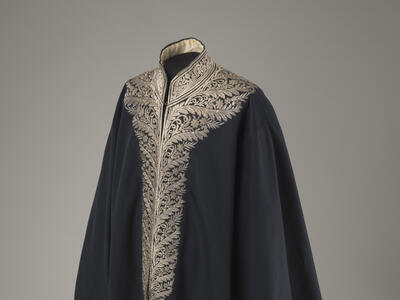 Coat with an ornately embroidered neckline.