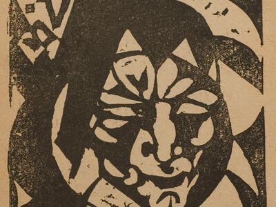 Woodcut of geometric, stylized face with Yiddish heading. 