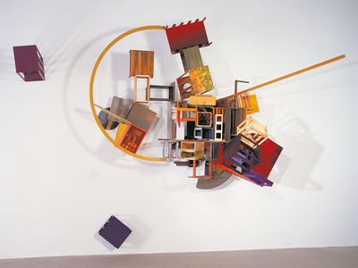 Industrial paint on wood sculpture mounted on wall featuring half moon shaped piece of wood and boxes.