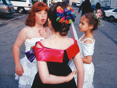 A Bat Mitzvah Party at the 20th Century Fox Movie Studio Commissary, West Los Angeles Three young girls wearing party dresses standing in a circle.