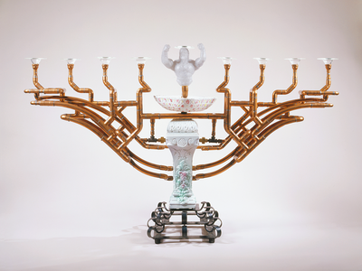 Ceramic menorah with eight copper branches and torso sculpture for center candle. 