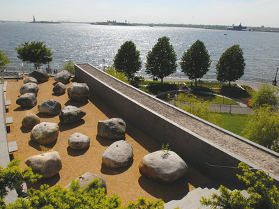 Aerial photograph of rock garden next to a building overlooking the sea. 