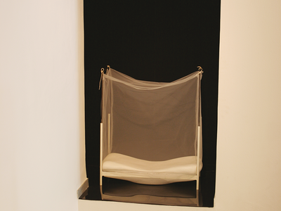 Installation depicting a wall inset with bed inside.