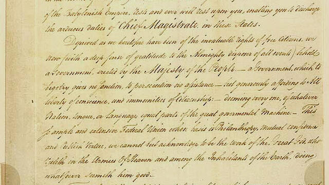 Handwritten letter in English with small stamp at top and signature on bottom.