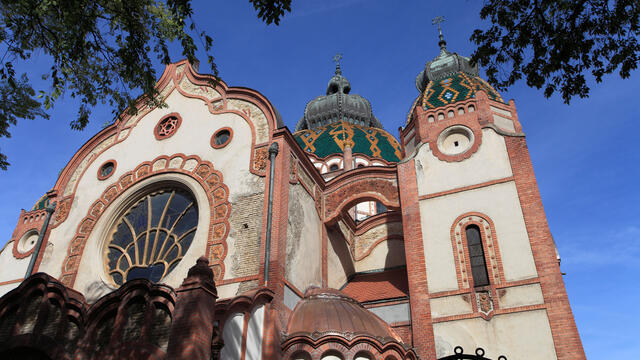 Photograph of building exterior with rounded roofs