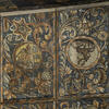 Close-up photograph of wood wall painted with foliage and image of elephant carrying castle and upside-down deer.