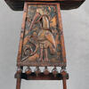 Wooden lectern with stork carving.