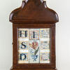 Wood wall piece with bold Hebrew letters and flowers