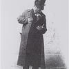 Photograph of man in top hat looking off to the side.
